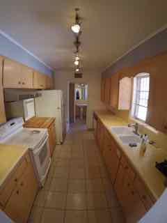 Galley kitchen with dishwasher, 23 cu ft fridge, glass-top stove, and new sink and faucet
